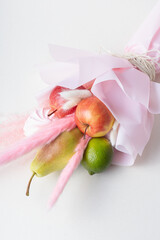 Food bouquet. Unusual bouquet of fruits and dried flowers. Edible bouquet for woman
