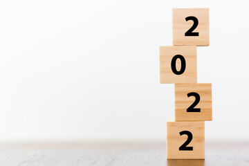 New year 2022 on wooden cubes on table with copy space