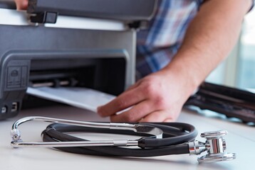 Repairman repairing broken color printer