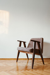 Grey vintage armchair on wooden parquet floor