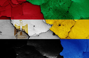 flags of Egypt and Gabon painted on cracked wall