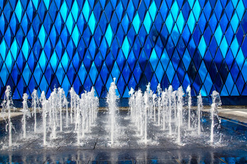 A low jets fountain on bright blue panel in the background. Located at EXPO 2020 in Dubai, UAE