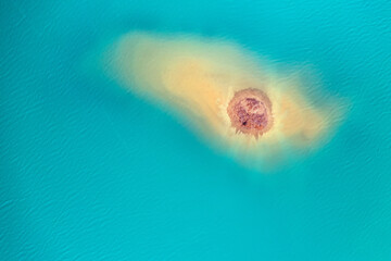 Quarry for mining and enrichment of titanium and other rare ores. Blue water in the enrichment tank.