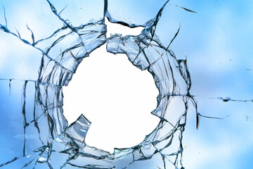 Cracks in the window glass on a background of sky.