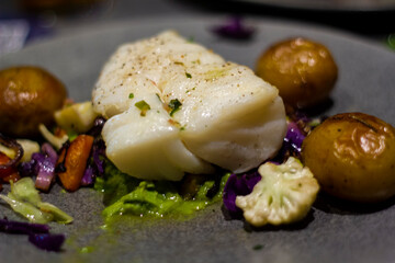 Fresh codfish with baked potatoes and vegetables