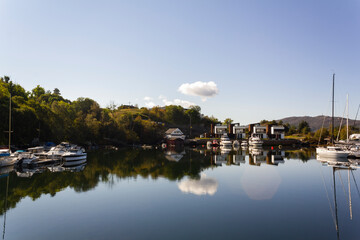 Fototapeta premium Yachts and houses reflected on calming water. Lifestyle in Norway