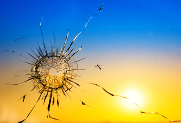 Hole in the glass from a bullet on the background of the flag of Ukraine