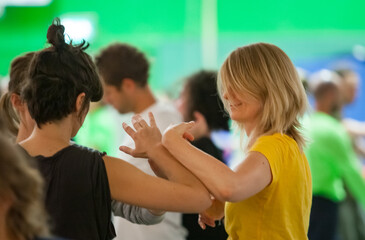 two experienced dancers contact hands in contact improvisation on the bg a CI jam intentionally with motion blur ond defocus bokeh