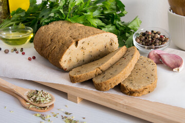 seitan or vegan meat sliced with spices such as oregano, pepper, garlic, and parsley.