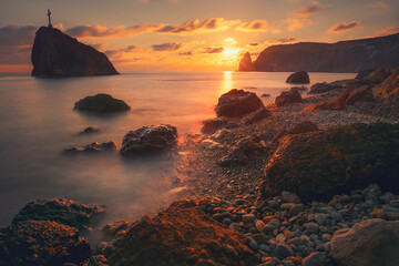 Beautiful sea coast with rocks at sunset. View of Jasper beach in Fiolent Cape, Crimea. Long exposure shot