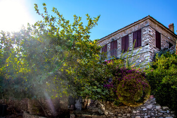 Fototapeta na wymiar A stone house with a garden in Doganbey Village, with its natural beauties famous. Historical and nostalgic stone houses. Soke, Aydin, Turkey.