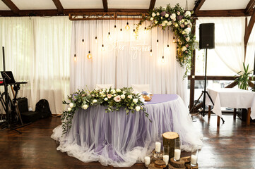 a beautiful arch at the wedding ceremony decorated with flowers stands on the outside. wedding decorations in rustic style.