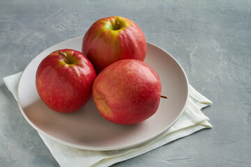 cripps pink apples on grey background