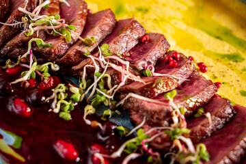 Grilled duck with polenta and sauce,