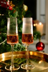 Selective focus glasses of champagne near the new year tree in the new year 2022