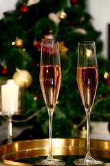 Selective focus glasses of champagne near the new year tree in the new year 2022