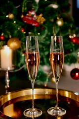 Selective focus glasses of champagne near the new year tree in the new year 2022