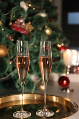 Selective focus glasses of champagne near the new year tree in the new year 2022
