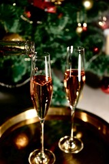 Selective focus glasses of champagne near the new year tree in the new year 2022