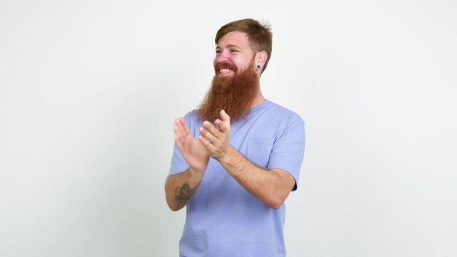 Redhead man with long beard applauding after presentation in a conference over isolated background