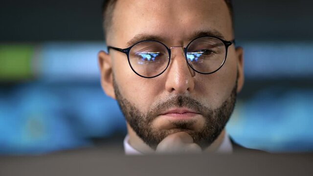Closeup bearded business man working laptop brainstorming at futuristic hi tech infographic screen