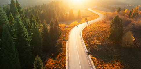 Paved road in the mountains. Autumn landscape at sunset.