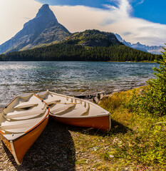 Fototapeta na wymiar Small Boats On Swiftcurrent Lake With Mt. Grinnell in The Distance, Glacier National Park, Montana, USA