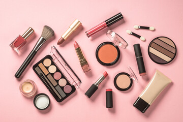 Make up products at pink background. Eye shadow, powder, cream, lipstick and more for professional make up. Flat lay image with copy space. - obrazy, fototapety, plakaty