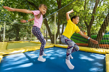 Happy children jumping on trampoline