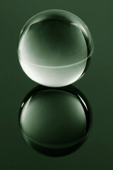 Transparent glass sphere on reflective surface