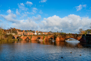 Obraz premium View of the old brick Dee Bridge over the river Dee in Chester, UK