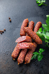 dry-cured sausages smoked sausage uncooked meat meal fast food snack on the table copy space food background rustic. top view