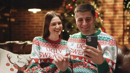 Family congratulates friends Merry Christmas on video communication. Couple sharing good news with friends and family on video chat during self isolation. Virtual celebration with friends video call - Powered by Adobe