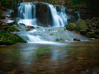 Wild brook with stones and waterfall in Jeseniky mountains, Eastern Europe, Moravia. Clean fresh cold watter, water stream. Long exposure image. .