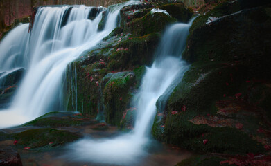 Wild brook with stones and waterfall in Jeseniky mountains, Eastern Europe, Moravia. Clean fresh cold watter, water stream. Long exposure image. .