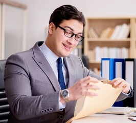 Businessman receiving letter envelope in office