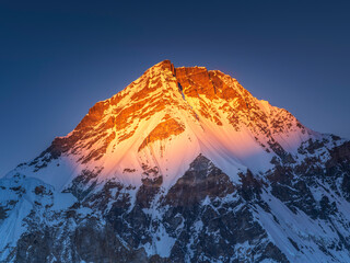 Snow spot of last light on summit Everest under blue sky in Nepal