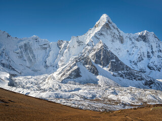 view to triangle peak through valley in sun shining day in Nepal