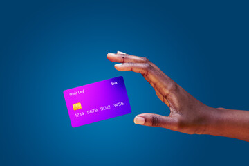 Close up african american female hand and levitating mockup bank credit card with online service on...