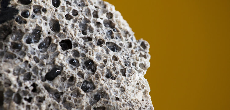 Meteorite rock detail, with light brown background.