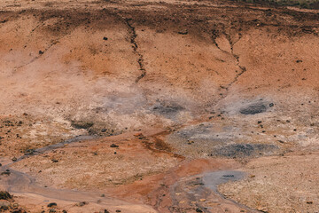 Empty geothermal Krysuvik area on Reykjanes peninsula in Iceland on early summer morning. Visible sulphur rising from the ground.