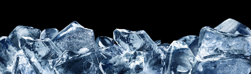 Shards of ice poured horizontally at the bottom, isolated on a black background. A strip of pieces...