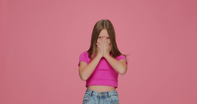 Bad smell. Kid girl pinch nose showing stop gesture, feel disgust on pink studio background. Terrible odor