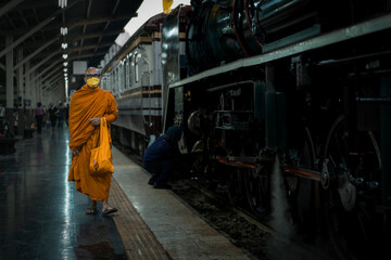 Monk walks into Bangkok Railway Station with an ancient Pacific type steam locomotives from Japan No.824 in special nostalgic trips.