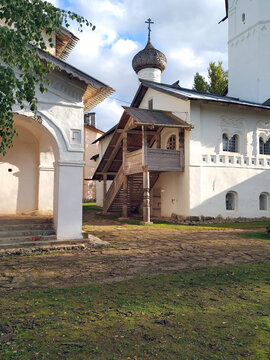 High wooden porch with carved elements in the Old Russian style. Entrance to the white-stone Russian church in the ancient city of Staraya Russa. Ancient Russian architecture of the XVI century. The R