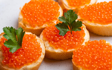 Salmon red caviar sandwich close-up