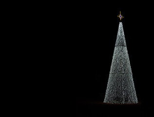 glowing christmas tree decoration on black background