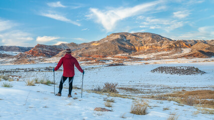 mature male hiker with trekking poles in Red Mountain Open Space, recreational area maintained by...