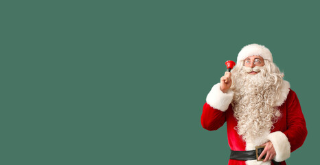 Santa Claus with Christmas bell on green background with space for text