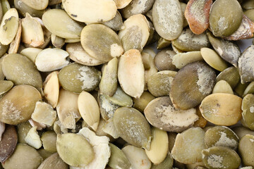 Heap of pumpkin seeds as background